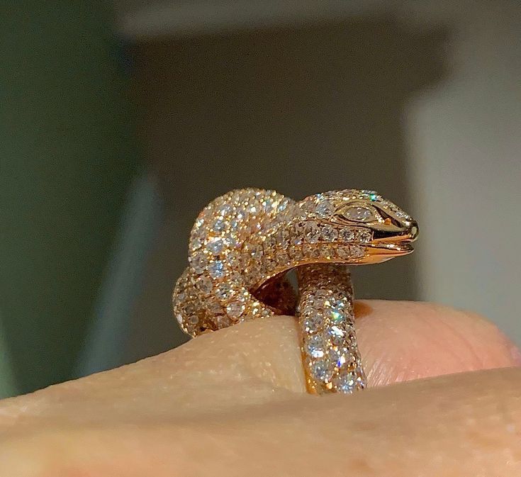 This awesome Diamond Snake Ring, A Victorian Symbol of Eternal Love. The eyes have 2 marquise cut diamonds encrusted. All the diamonds are white and very sparkling. Good quality diamonds and the ring is solid 18K Rose gold, feels nice and heavy. Diamonds all set smooth. You see sparkles from any direction all covered with diamonds. This is definitely a conversation piece work of art to behold. Genuine natural round brilliant cut diamonds total weight: 4.25 carats Clarity: SI Color: F/G Our diamo Luxury Rose Gold Marquise Diamond Ring, Luxury Snake Ring With Diamond Accents, Luxury Diamond Snake Ring, Luxury Snake Ring With Diamond Accents For Anniversary, Diamond Snake Ring With Single Cut Diamonds As Gift, Luxury Diamond Eyes Rings For Anniversary, Luxury Anniversary Rings With Diamond Eyes, Luxury Marquise Cut Diamond Ring In Rose Gold, Luxury Snake Ring With Single Cut Diamonds For Anniversary