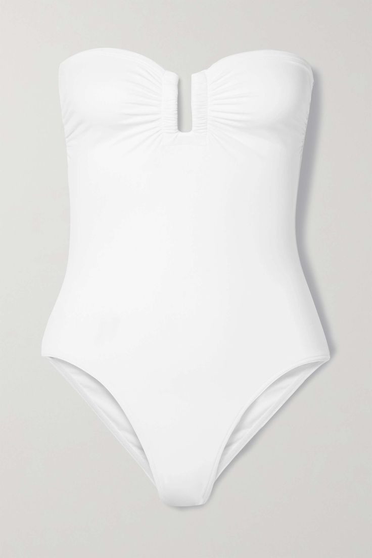 A timeless summer staple, Eres' sleek bandeau swimsuit is cut from the brand's signature peau douce fabric for an ultra smooth silhouette. It's designed with a concealed U-ring for structure and gummed internal band that keeps it securely in place. Luxury One-piece Swimwear For Summer, Luxury Summer Swimwear For Vacation, White Swimwear For Beach, Minimal Stretch White Swimwear For Beach, Elegant Swimwear With Lined Body And Minimal Stretch, Luxury Fitted Swimwear For Summer, Luxury Fitted Beach Swimwear, Elegant Minimal Stretch Swimwear For Poolside, Classic One-piece Swimwear For Summer