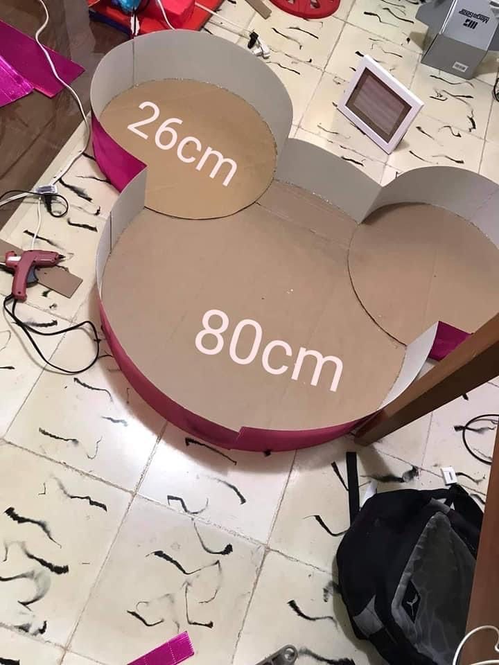 a cardboard mickey mouse head cut out on the floor