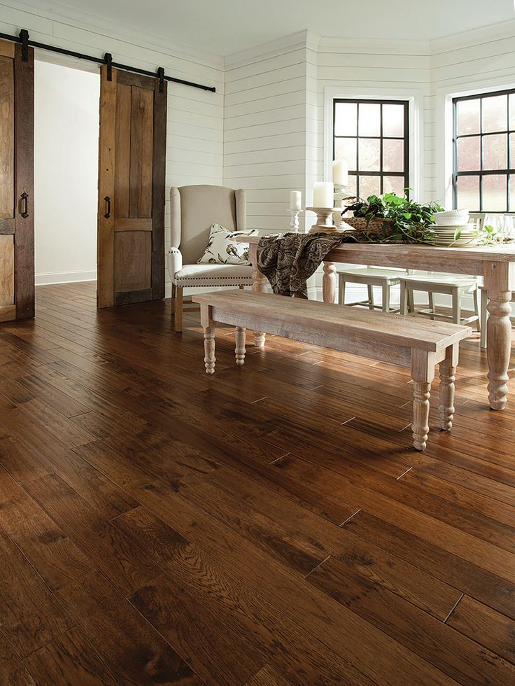 a wooden floor with a bench in the middle and two doors leading to another room