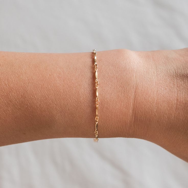 "For those looking for a dainty bracelet that is absolutely darling, meet our Dapped Chain Bracelet. This bracelet is very lightweight and comfortable, making it perfect to wear all the time! Ready for gift giving! . . . . . . . . . . . . . . . . . . . . . . . . . . . . . . . . . . . . . . . . . . BRACELET + Bracelet length: 6.5\" with 1.5\" extender + Gold filled -or- sterling silver chain, lobster clasp, & findings + Matching necklace: https://www.etsy.com/listing/894830947 LAYER LIKE PHOT Delicate Chain Bracelet With Extender, Adjustable Delicate Chain Charm Bracelet, Dainty Gold Bracelet With Extender, Dainty Chain Bracelet As Gift, Delicate Bangle Bracelets For Bridesmaids, Dainty Adjustable Chain Bracelet, Dainty Adjustable Paperclip Bracelet, Delicate Paperclip Bracelet Gift, Delicate Paperclip Bracelet For Gift