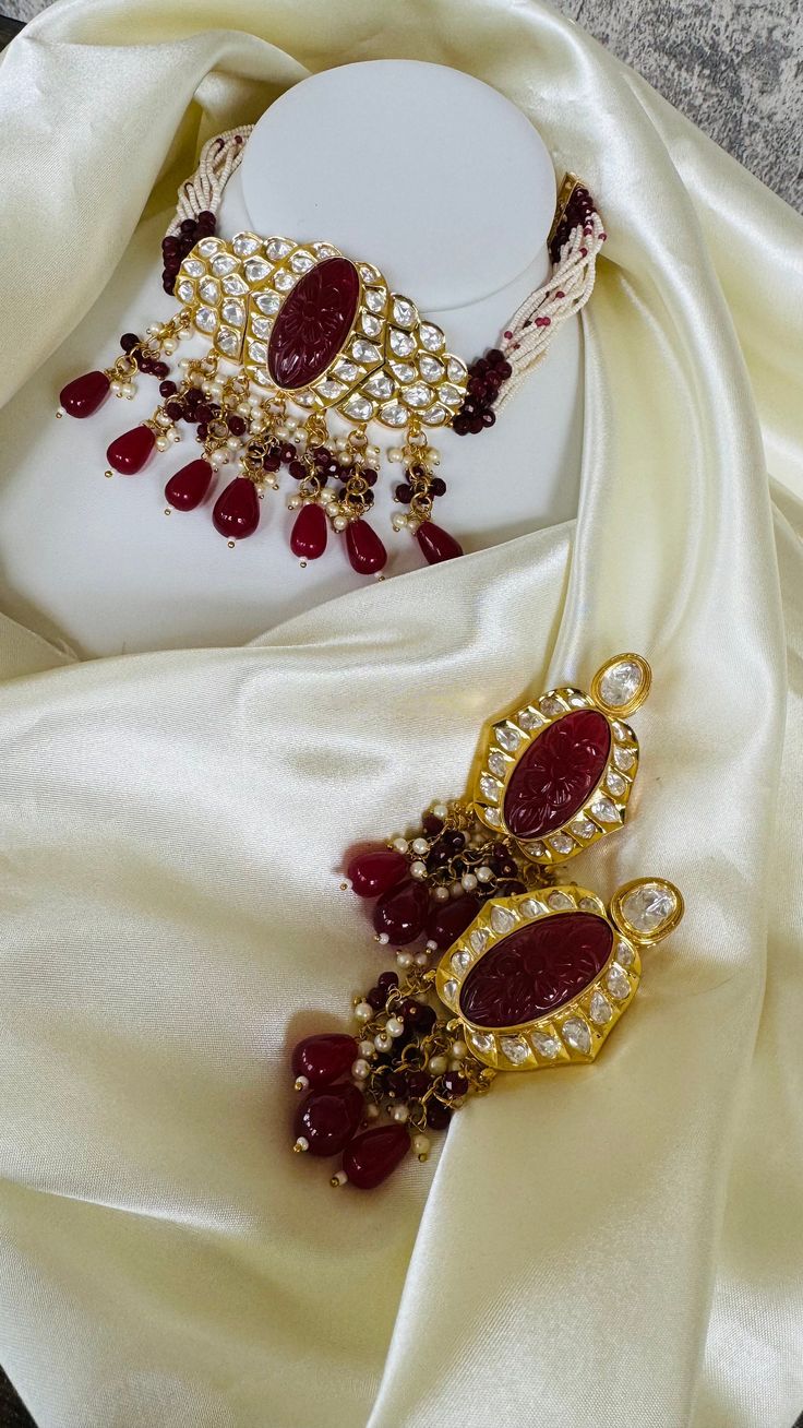 Tyaani kundan necklace with Ruby carved stone on the center to give a real piece look. Intricate Kundan Tikka For Puja, Temple Style Bridal Necklace For Festivals With Cut Dana, Festival Temple Jewelry Bridal Necklace With Cut Dana, Festive Temple Bridal Necklace With Cut Dana, Temple Style Kundan Necklace With Pendant Stone Setting, Temple Style Kundan Pendant Necklace With Stone Setting, Temple Style Kundan Pendant Necklace, Temple Jewelry Style Kundan Necklace With Pendant, Ceremonial Stone Setting Jewelry For Diwali