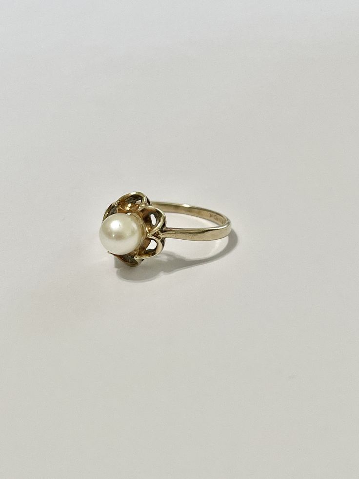 Beautiful vintage 10k yellow gold cultured pearl ring! This classic piece features a beautiful cultured pearl in a buttercup setting. Stunning retro piece of fine jewelry showcasing June's birthstone, circa 1950s! ERA - Circa 1950s, Retro MARKINGS / MATERIAL - 10k yellow gold , 1 cultured pearl MARKINGS / HISTORY - 10k gold and Siffari marking CONDITION - Good vintage condition. Very little age consistent wear. A timeless retro ring! SIZE / MEASUREMENTS - Size: 6, Rise of ring off of finger: 8 m Classic Pearl Drop Ring, Classic Yellow Gold Rings With Pearl Drop, Antique 14k Stamped Pearl Ring For Wedding, Antique 14k Gold Pearl Wedding Ring, Antique 14k Stamped Pearl Wedding Ring, Vintage White Gold Pearl Ring For Formal Occasions, Vintage White Gold Pearl Ring For Formal Events, Antique Pearl Ring For Wedding, Vintage White Pearl Ring