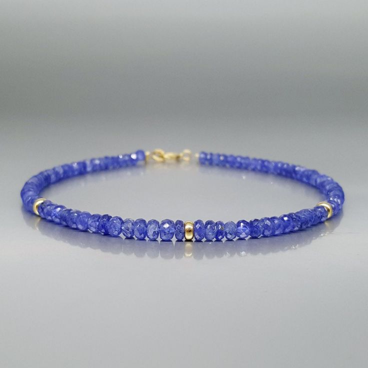 Fine bracelet blue Sapphire with 14k parts and clasp. Handmade unique gift for her, September birthstone, 5 and 45 year anniversary gift.  Extraordinary blue beads of Sapphire, faceted to perfection in many small faces, sparkling and shining with an elegance. The bracelet is enhanced with 14K gold parts. The stones are strung on stainless steel for maximum hold and finished with a 14K gold clasp and tiny 14K gold parts are set as elegant accent.  Dimensions & features: ▪️ Genuine Sapphire ▪️ Bea Blue Faceted Rondelle Bracelets, Faceted Sapphire Beaded Bracelets As Gift, Blue Tanzanite Bracelet, Blue Tanzanite Bracelet Jewelry, Elegant Blue Rondelle Bracelets, Elegant Blue Faceted Bracelets, Blue Faceted Beaded Bracelets As Gift, Tanzanite Faceted Beads Jewelry For Gift, Blue Faceted Beaded Bracelets For Gift