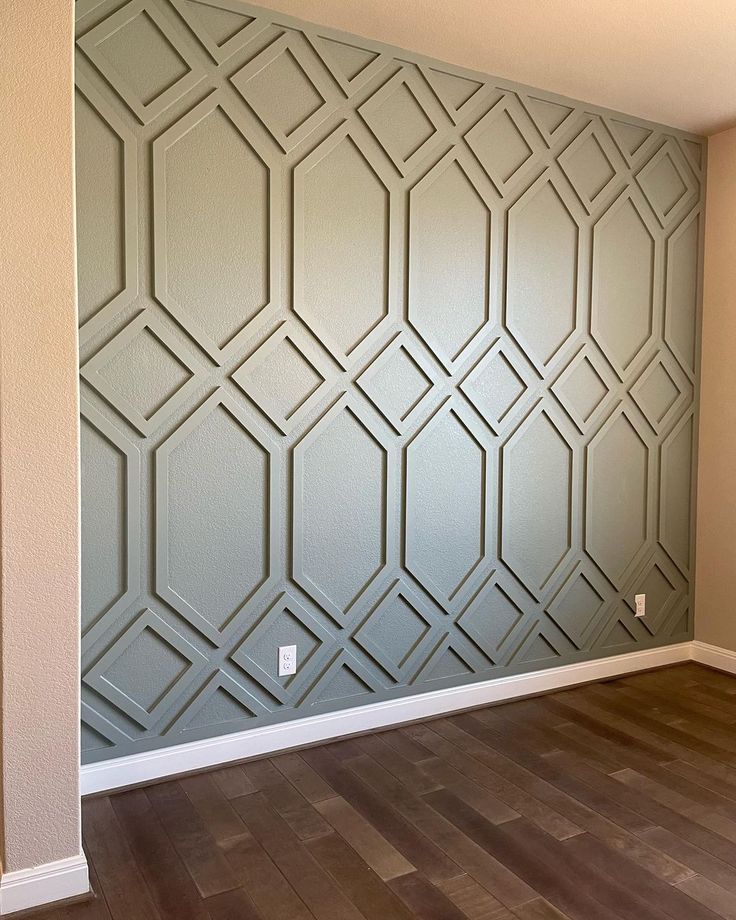 an empty room with wood flooring and a wall painted in grey color, it looks like something from the future