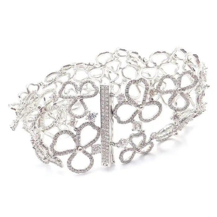 This is part of Chairish’s Fine Jewelry assortment.  Platinum Diamond Paper Flowers Wide Bracelet by Tiffany & Co. With Round Brilliant Cut Diamonds, VS1 clarity, G color. Total Diamond Weight: 12.0ct.   T&Co. Retail Price: Approx. $100,000.  Details: Weight: 55.7 grams Length: 7" Width: 31mm Stamped Hallmarks: Tiffany&Co Pt950 item #: T3533tommd Luxury White Bracelet For Evening, Evening Diamond Bracelets With Sparkling Stones, Diamond Bracelets With Sparkling Stones For Evening, Luxury White Bracelets For Evening, Designer Silver Diamond Bracelet With Accents, Luxury Silver Diamond Bracelet With Elegant Design, Elegant Evening Bracelets With Sparkling Stones, Elegant Diamond Bracelets For Party, Silver Cubic Zirconia Diamond Bracelet For Evening