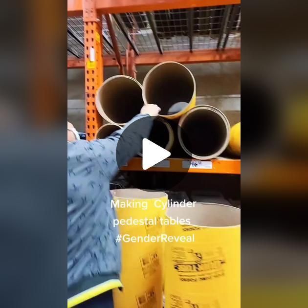 a man is holding up some pipes in a warehouse with the caption making cylinder decorative tables