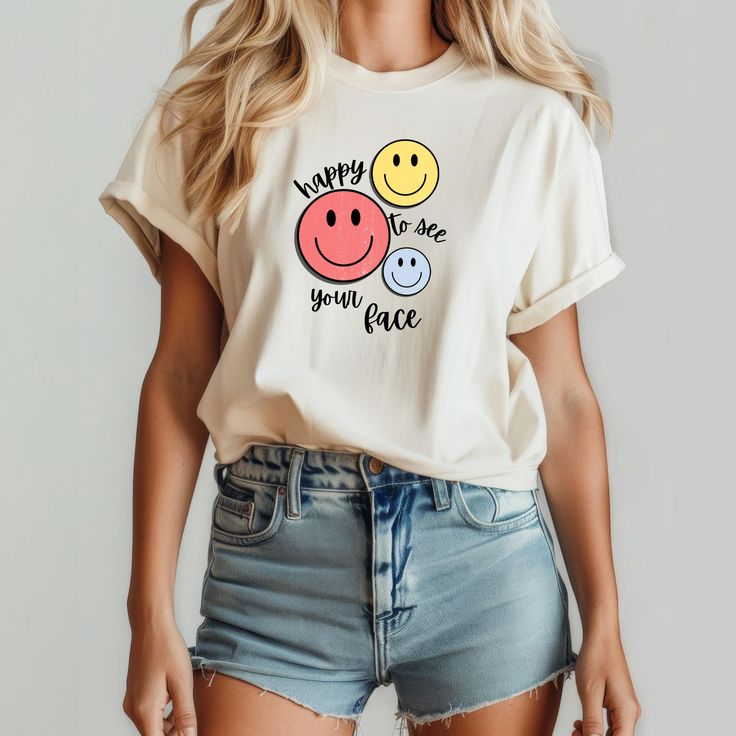 A cheerful and fun graphic T-shirt featuring a smiley face design, perfect for teachers or anyone who wants to spread positive vibes. This tee is made with lightweight cotton, making it ideal for everyday wear and layering. The retail fit and classic crew neckline add a neat and versatile style that can easily be accessorized. Great for casual and semi-formal settings, this tee is a must-have for those looking to add a touch of happiness to their wardrobe. Product features - Lightweight 100% Air Playful White T-shirt With Smiley Face, Funny Graphic Print Tops For Everyday, Fun Cotton T-shirt With Smiley Face, Fun Slogan T-shirt For Everyday, Trendy T-shirt With Funny Text For Everyday, Trendy Everyday T-shirt With Funny Text, Playful Everyday Tops With Letter Print, Trendy Funny Text T-shirt For Everyday, Playful Letter Print Tops For Everyday