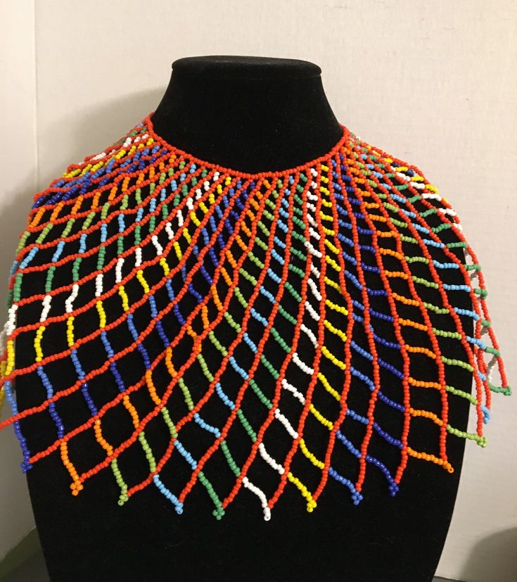 Beautiful, Multicolored beaded Egyptian/African/Multicultural Collar Necklace. Made of intricate seed beads with an adjustable ball closure. Necklace length 16 inches, Height 8 inches, Width 26 inches. Unique Multicolor Small Beads, Artisan Multicolor Beaded Necklace, Traditional Multicolor Beaded Chain, Festival Beaded Choker, Festival Beaded Choker With Round Beads, Artisan Multicolor Beaded Chain Necklace, Traditional Colorful Beads Bib Necklace, Multicolor Beaded Necklaces For Festivals, Multicolor Round Beads Necklace For Festivals