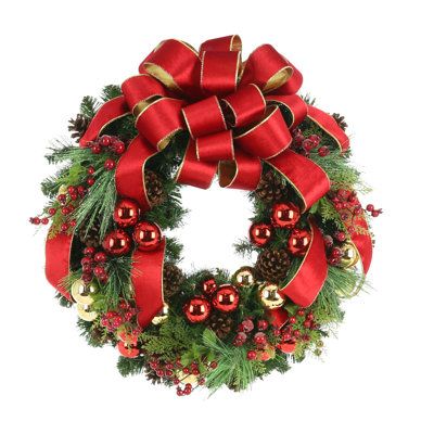 a christmas wreath with red bows and ornaments