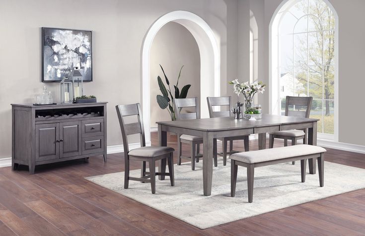 a dining room table with chairs and a bench