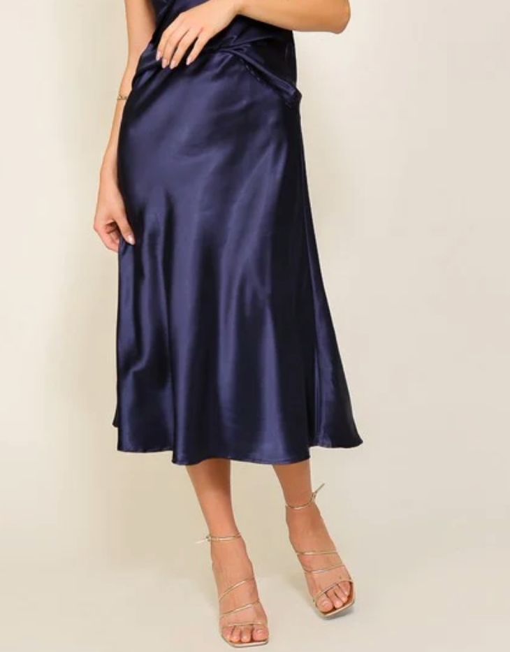 This luxuriously elegant skirt, with a silhouette that gently cascades down to a flirtatious, mid-calf length. Its wondrous blend of lustrous satin and a cinched elastic high waistband offers an enchanting flair that's both flattering and comfortable. A true masterpiece that will leave onlookers in awe with its mesmerizing flow and refined style. This is the flare midi satin skirt that you have been longing for, perfect for any occasion that calls for sophistication and class.PRODUCT SPECIFICATIONS*Fabric Contents: 97% Polyester, 3% Spandex*Care Instructions: Machine wash cold, gentle cycle, tumble dry low.*Brand: Timing*Model is wearing a size SmallMEASUREMENT (inches)*S: 13.0 (Waist), 29.5 (Length)*M: 13.5 (Waist), 30.0 (Length)*L: 14.0 (Waist), 30.5 (Length) Chic Pleated Satin Skirt, Satin Pleated Skirt For Night Out, Feminine Flowy Skirt For Night Out, Elegant Silk Bottoms For Date Night, Chic Satin Finish Bottoms For Party, Elegant Satin Bottoms For Spring, Chic Bottoms With Satin Finish For Party, Chic Party Bottoms With Satin Finish, Feminine Satin Bottoms For Evening