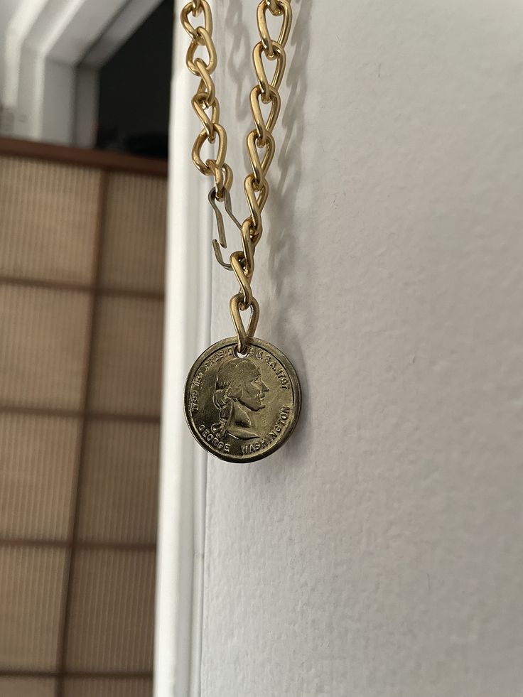 Cute vintage gold tone faux coin pendant. The chain is a coppery gold color and the pendant is more yellow gold. *Not a real coin!! Just a fun trinket necklace. Not a high quality piece. Very lightweight. Has tone wear from age. Measures approximately 33 inches Pendant - 1 inch Vintage Metal Coin Pendant Necklace, Vintage Metal Necklace With Coin Pendant, Vintage Chain Necklace With Coin Pendant, Vintage Gold-tone Chain Necklace With Coin Pendant, Vintage Metal Medallion Necklace With Coin Pendant, Vintage Coin Shaped Medallion Necklace, Gold Coin-shaped Nickel-free Necklace, Gold Metal Locket Necklace With Vintage Charm, Gold Coin Necklace Nickel Free