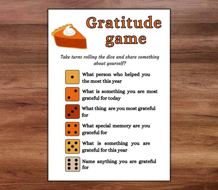 a card with some dices on it and the words gratitude game