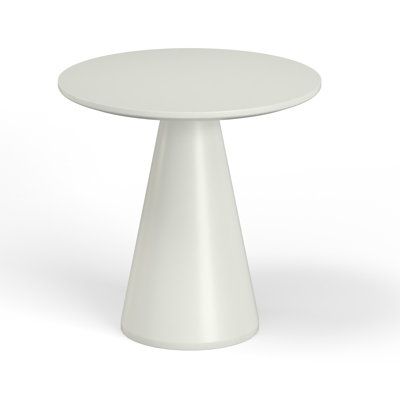 a white round table sitting on top of a white floor