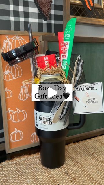 a coffee cup filled with items sitting on top of a table next to a sign