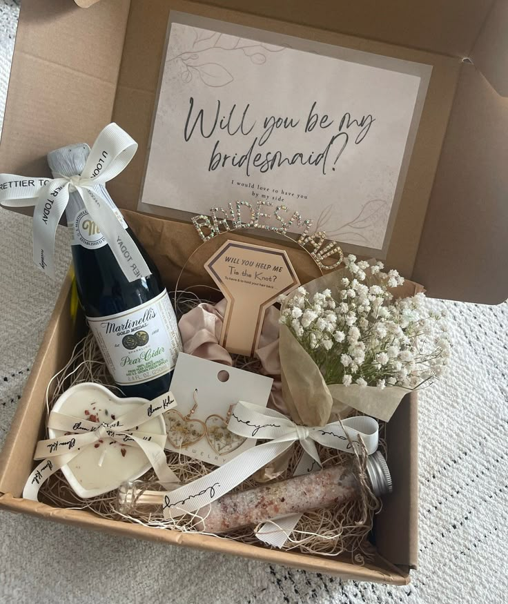 a box filled with wine and flowers on top of a table