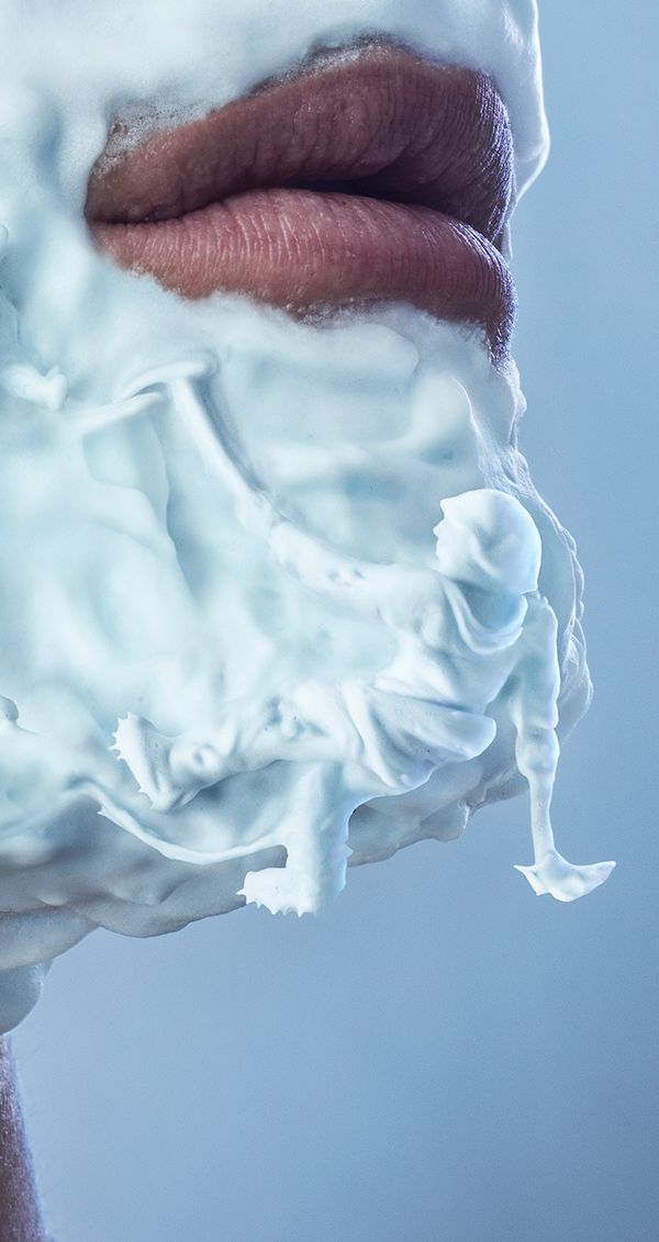 a close up of a person's face covered in white frosting and icing