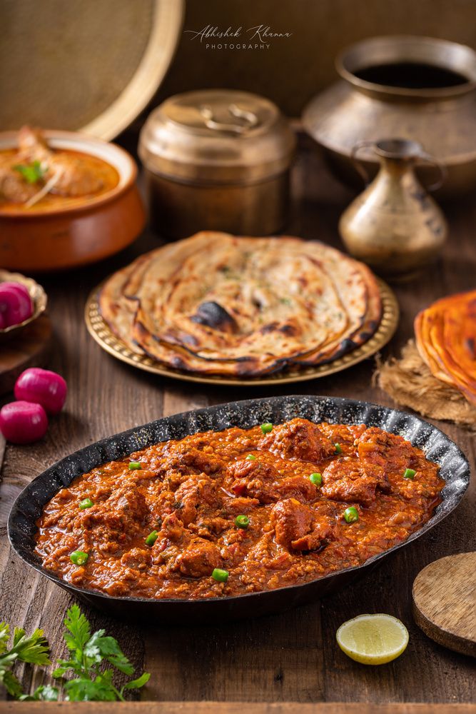 some food is sitting on a table with other foods in bowls and plates around it