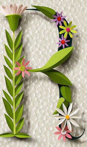 the letter e is made out of paper and decorated with flowers, leaves and petals