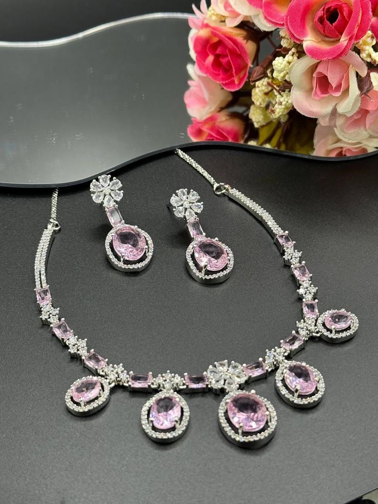 Big pink stones with intricate American Diamonds floral design  Crafted with precision, each sparkling diamond complements the rich baby pink hue creating a striking contrast. Perfect for special occasions or to add a touch of luxury to your everyday style! Pink Flower-shaped Cubic Zirconia Jewelry, Wedding Jewelry With Diamond Accents And Pink Sapphire, Pink Round Necklace For Party, Formal Blush Diamond Jewelry, Elegant Pink Flower-shaped Jewelry, Glamorous Pink Jewelry For Celebration, Feminine Pink Flower-shaped Jewelry, Pink Jewelry With Diamond Accents In Cubic Zirconia, Pink Crystal Jewelry With Diamond Accents