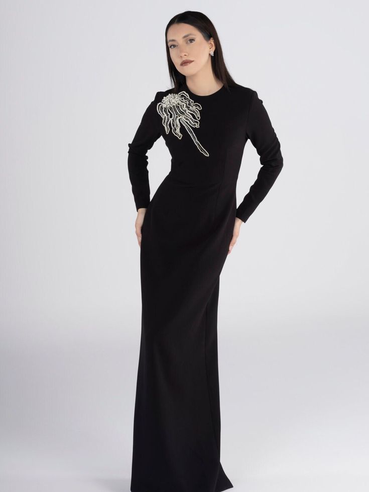 Luxurious black crepe maxi dress, designed for special occasions. Exquisite pearl embellishment and intricate crystal stone detailing. Ideal for formal events, evening soirées, or any glamorous affair. Make a statement with this fashionable and elegant piece. Embellished Long Sleeve Maxi Dress For Formal Events, Embellished Long Sleeve Maxi Dress For Formal Occasions, Long Sleeve Embellished Maxi Dress For Formal Events, Luxury Embellished Long Sleeve Maxi Dress, Luxury Embellished Evening Maxi Dress, Luxury Embellished Maxi Dress For Evening, Luxury Embellished Maxi Evening Dress, Luxury Embellished Maxi Dress For Formal Occasions, Embellished Cocktail Maxi Dress