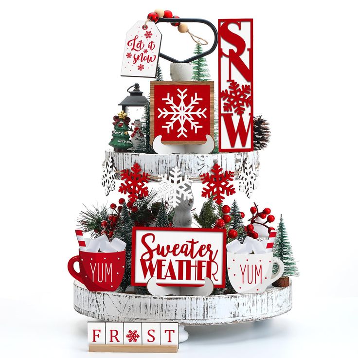 a white christmas tree with red and white signs on it's sides, including snowflakes