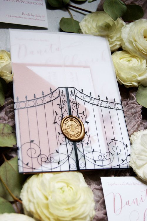 a close up of a wedding stationery with flowers