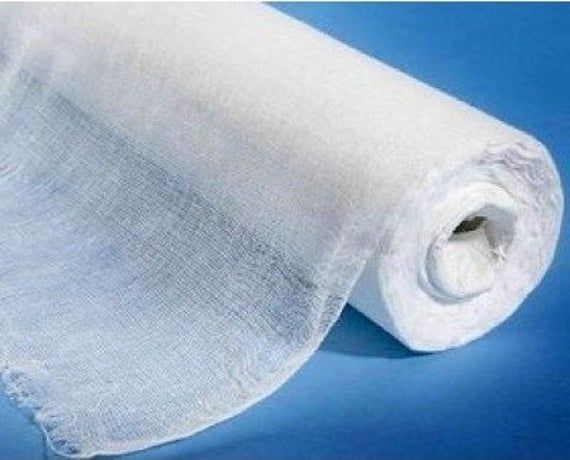 a roll of white fabric on a blue background