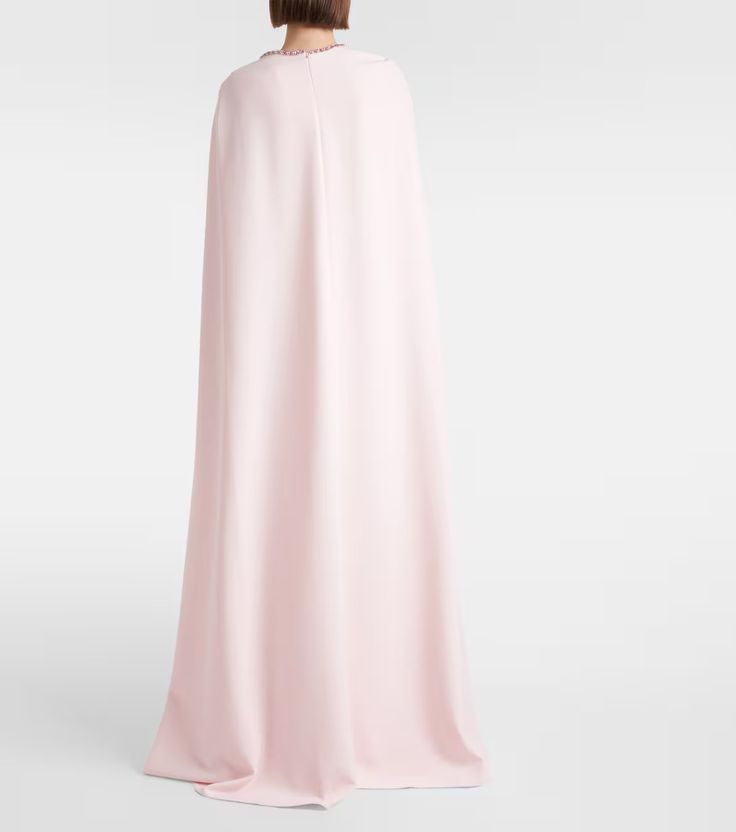 Mattia caped embellished crêpe gown in pink - Safiyaa | Mytheresa Pre-draped Cape Evening Dress, Elegant Gown With Cape Sleeves, Formal Embellished Maxi Dress With Cape Sleeves, Embellished Gown With Cape Sleeves, Evening Cape Maxi Dress With Draped Sleeves, Evening Maxi Dress With Cape Sleeves, Evening Maxi Dress With Draped Sleeves And Cape Shape, Glamorous Dresses With Cape Sleeves, Cape Evening Dress With Sweep Train