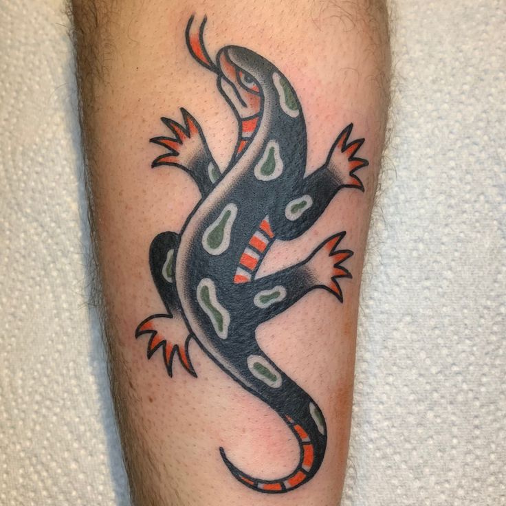 a lizard tattoo on the leg