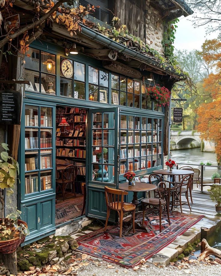 a book store with lots of books on the shelves and tables in front of it