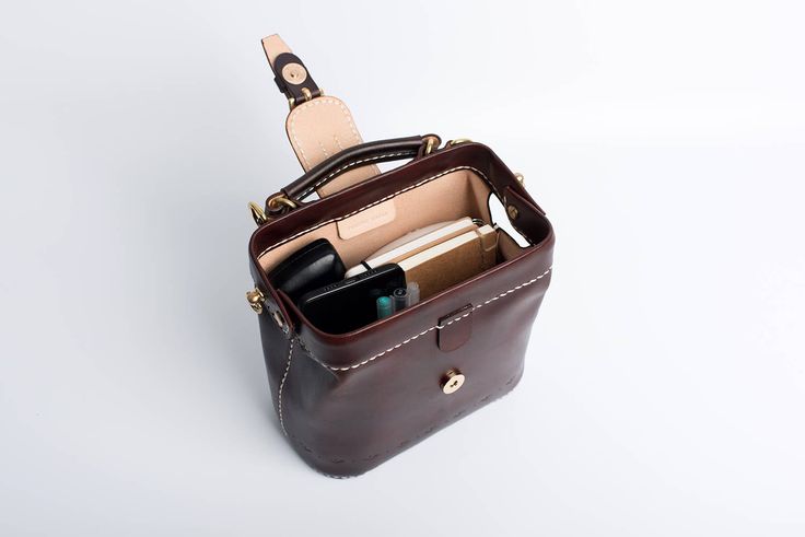 "*DOCTOR BAG'S HANDMADE VIDEO* https://youtu.be/QpdhSCjh2BM Product Description * Material: vegetable tanned leather * Color: Hand-dyeing -Chocolate * Flap over entry with magnetic buckle closure * 0.75\" wide leather shoulder strap adjust from 36.61\" to 44.88\" * Sewn by hand; * Size: 170mm (H) x 180mm (W) x 110mm (D) / 6.7\" x 7.0\" x 4.3\" The Installation of Doctor Bag Frame #Please see the last picture# Doctor Bag Frame is connected by two pairs of screws. Although we will tighten the scre Leather Doctor Bag, Leather Handheld Phone Bag For Everyday Use, Everyday Leather Handheld Phone Bag, Everyday Handheld Leather Phone Bag, Leather Bucket Box Bag As A Gift, Daily Use Bucket Bag Satchel With Cell Phone Pocket, Handheld Leather Satchel With Cell Phone Pocket, Leather Satchel Phone Bag For Office, Leather Mobile Phone Box Bag For Travel