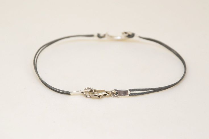 crescent moon and star bracelet for men - cord bracelet with a silver tone moon and star charm. The color of the cords is gray and made of waxed cotton. The charm is zinc alloy metal. You can request a different cord color from the colors shown in the last picture. The bracelet is 7 1/2 inch long. If you would like a different length, please choose your option at checkout. This bracelet is great as a gift for a man or a boy. All of our jewelry comes wrapped and ready for gift giving! *if you wou Everyday Silver Braided Bracelet With Sliding Knot, Silver Jewelry With Sliding Knot For Everyday, Silver Minimalist Jewelry With Adjustable Clasp, Minimalist Silver Braided Bracelet For Friendship, Everyday Silver Jewelry With Sliding Knot, Silver Sliding Knot Bracelet For Everyday, Minimalist Silver Bracelet With Adjustable Clasp, Minimalist Silver Jewelry With Adjustable Clasp, Minimalist Silver Bracelets With Sliding Knot