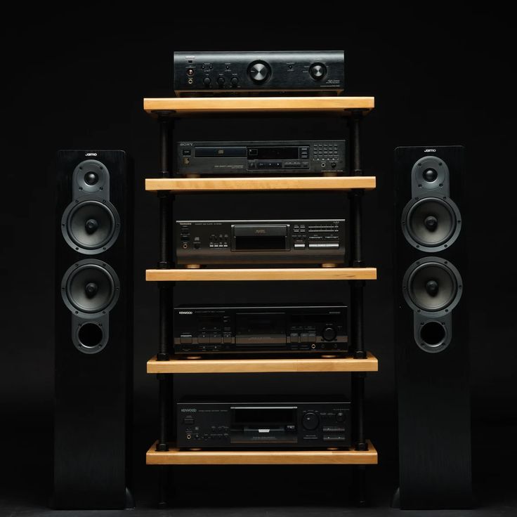 an array of speakers and audio equipment are stacked on top of each other in front of a black background