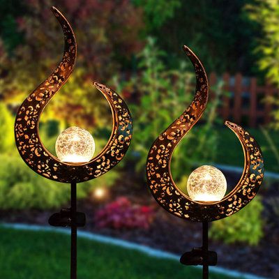 two decorative solar powered lights in the shape of crescents