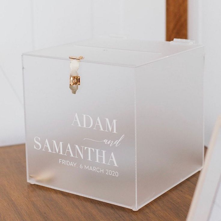 an acrylic box with the name adam and samantha on it sitting on a table