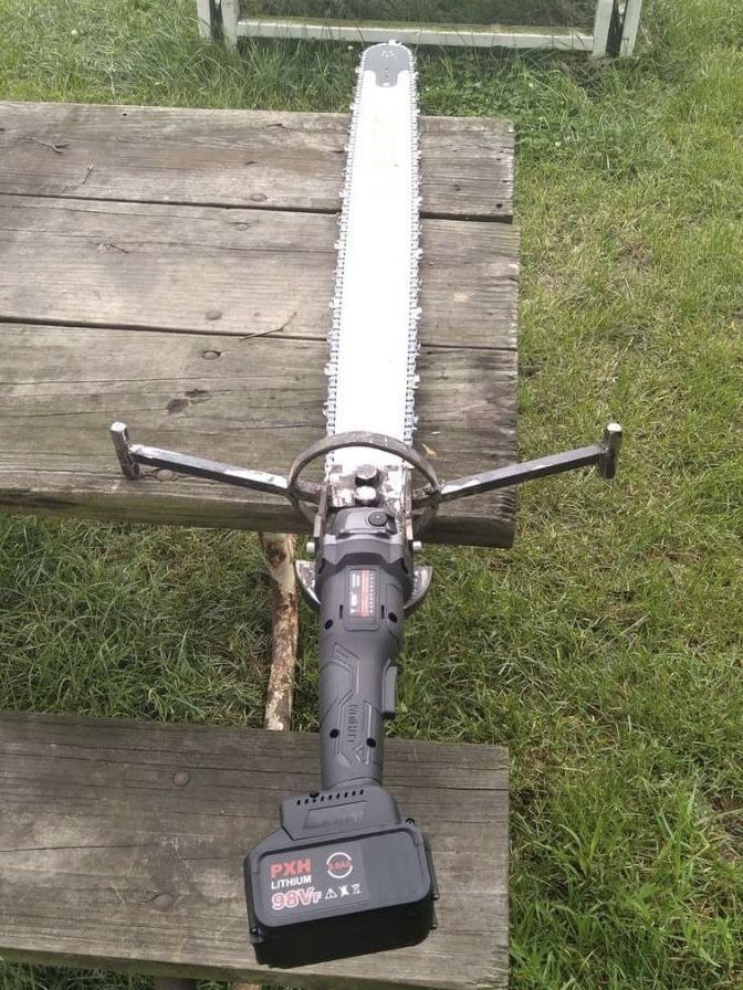 a close up of a bike on a wooden bench with grass in the back ground