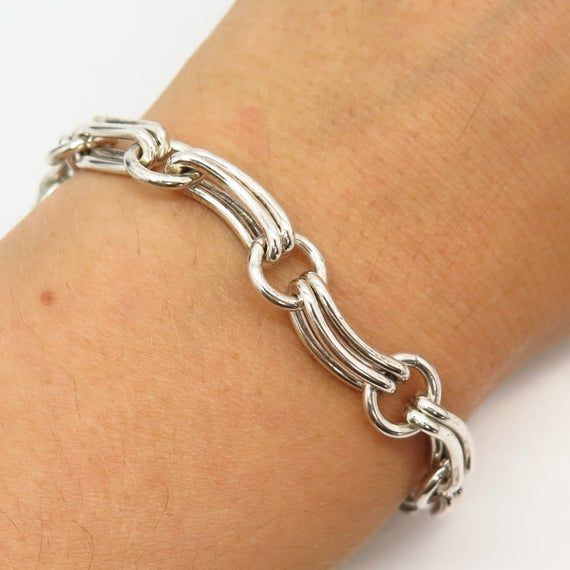 925 Sterling Silver Curved Design Fancy Link Bracelet 6 3/4"Weight: 26.8gWELCOME TO PAWN SHOPWe are an actual pawn shop and have been in business for over 25 years.Since 1990, our establishment has been serving a variety of clients by providing them with short term cash solutions and options of liquidity regarding their treasured heirlooms.Acknowledging that today′s customers are very sophisticated and are looking for a variety of investments, our acquisitions are hand-picked for our special cli Anniversary Silver Chain Bracelet With Solid Link, Silver Hallmarked Chain Bracelet, Swirl Ring, Curve Design, Pawn Shop, Amethyst Gemstone, Hand Picked, 25 Years, Link Bracelets