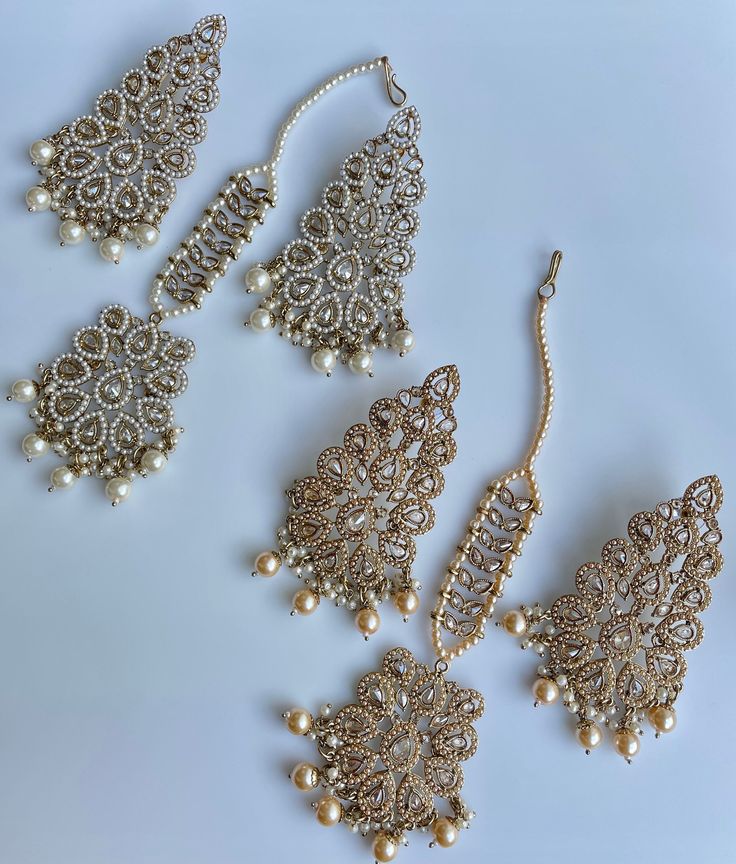 These gorgeous sets of tikka and jhumka come in 2 beautiful colors and are pastel tones to match any outfit. The multi set is a subtle mix of colors to create a uniform look and the champagne is the perfect single pop of color for any outfit! Comes as a set of earrings and headpiece (tikka) Traditional Cream Jewelry For Wedding, Bridal Earrings For Wedding And Eid, Festive Gold Fusion Sets, Festive Fusion Gold Sets, Elegant Chandbali Sets With Matching Earrings, Fusion Style White Bridal Earrings For Parties, Elegant White Danglers For Eid, Elegant Tikka With Latkans For Diwali, Party Hand Set Tikka