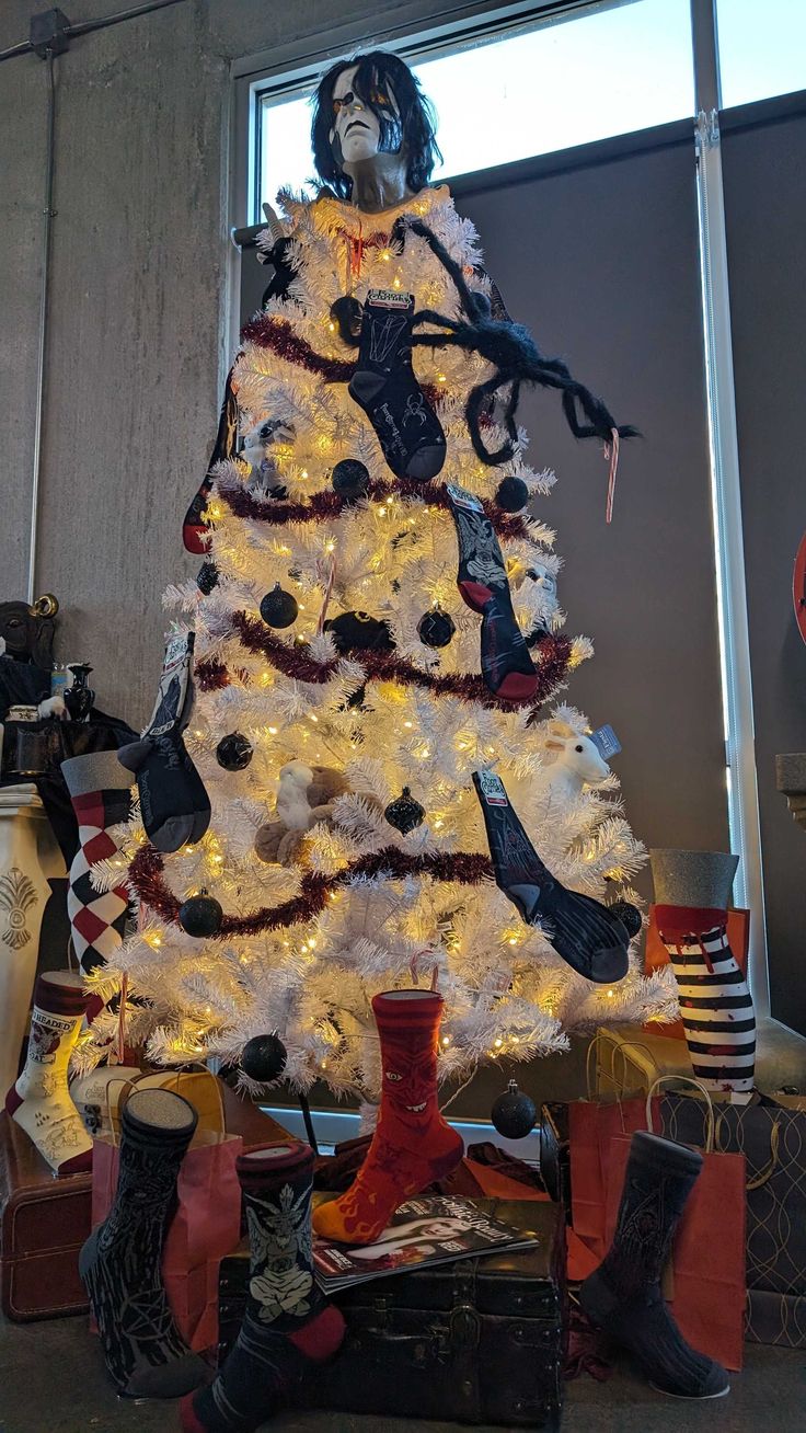 a white christmas tree with red and black decorations