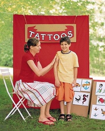 an image of two children in front of a tattoo booth