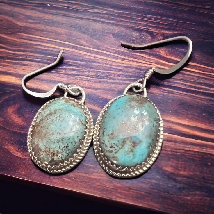 Ernest Hawthorne Turquoise & Sterling Silver Earrings Complete your look with these stunning earrings made from genuine turquoise and sterling silver. Add a touch of elegance and beauty to any outfit with these stylish and versatile accessories. Earrings are approximately 3/4 inch long. Artisan Turquoise Sterling Silver Earrings, Nickel-free Turquoise Sterling Silver Earrings, Artisan Turquoise Oval Earrings, Turquoise Oval Earrings With Natural Stones, Nickel-free Oval Turquoise Earrings, Painted Hats, Silver Chain For Men, Buckles Fashion, Genuine Turquoise