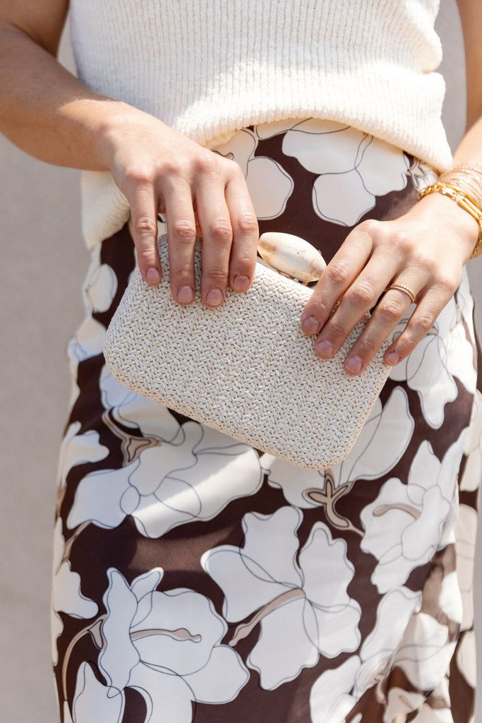 Product Description This box clutch features an all-over woven rattan design and is completed with a marbled resin clasp for the perfect finishing touch to any summer outfit. Details Removable gold-tone chain strap included Marble resin clasp closure measures 2" in length All-over woven rattan design Bag measures: 7.5" Wide, 4.5" High, 2" Deep Summer Rectangular Clutch With Chain Strap, Elegant Clutch As Fashion Accessory For Spring, Elegant Spring Fashion Accessory Clutch, Elegant Beige Clutch For Summer, Chic Summer Clutch For Fashion, Rectangular Clutch For Spring, Elegant Woven Clutch For Vacation, Spring Rectangular Clutch, Chic Summer Formal Clutch