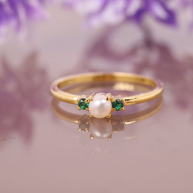 Freshwater Pearl Emerald Ring, 14K Solid Gold Ring, Engagement Ring, June birthstone, Three stone Ring, Anniversary Gift For Women's Jewelry Main Stone: Fresh Water Pearl Main Stone Color: White Main Stone Shape: Round Main Stone Size: 5mm Birthstone Month: June Second Stone: Emerald Stone Shape: Round Stone Color: Green Jewelry Type: Ring Metal: Silver Method: Cast Personalization: Possible Style: Chevron Ring Size: We make rings from US 3 to US 10. This elegant ring is perfect for any occasion Fine Jewelry Pearl Ring With Birthstone, Yellow Gold Pearl Birthstone Ring For Promise, Dainty Pearl Birthstone Ring For Anniversary, Fine Jewelry Pearl Ring With Birthstone For Anniversary, Fine Jewelry 14k Gold Birthstone Pearl Ring, 14k Gold Pearl Birthstone Ring Fine Jewelry, Gold Cluster Ring For May Birthstone, May Birthstone Multi-stone Wedding Ring, Stackable May Birthstone Ring For Wedding