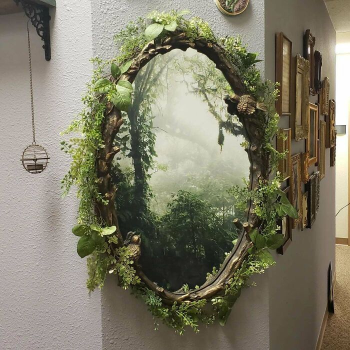 a mirror hanging on the side of a wall