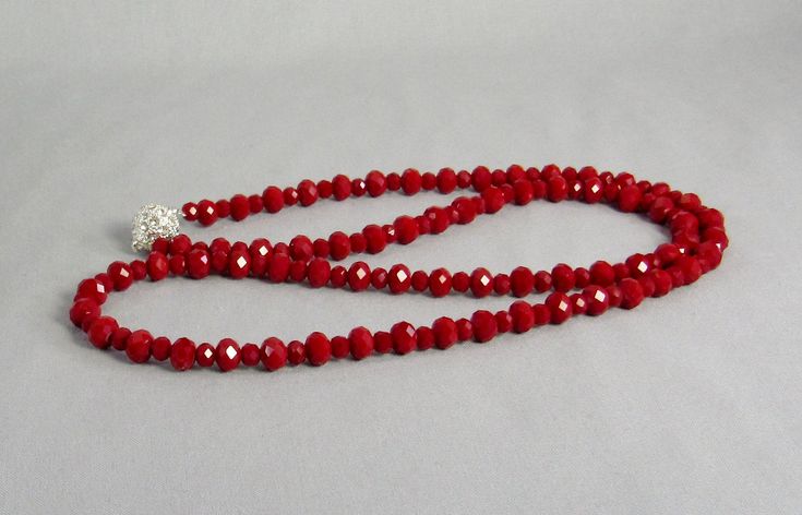 Opaque with sparkle, these red crystal beads are easy to wear and striking! The crystal rondelle beads are small to medium size with plenty of facets to reflect the light. Slip it on over your head or use the beautiful rhinestone magnetic clasp. It is 30 inches long (76 cm) and lightweight enough to layer with other necklaces. It is made with 4mmx6mm and 6mmx8mm beads. This necklace and all KBeadsIt jewelry ship fast and free with USPS first class domestic package service. The black, silver, and Deep Red Velvet, Crystal Heart Earrings, Freshwater Pearl Jewelry, Iridescent Crystal, Crystal Bead Necklace, Buy Bead, Long Red, Red Crystals, Red Bead