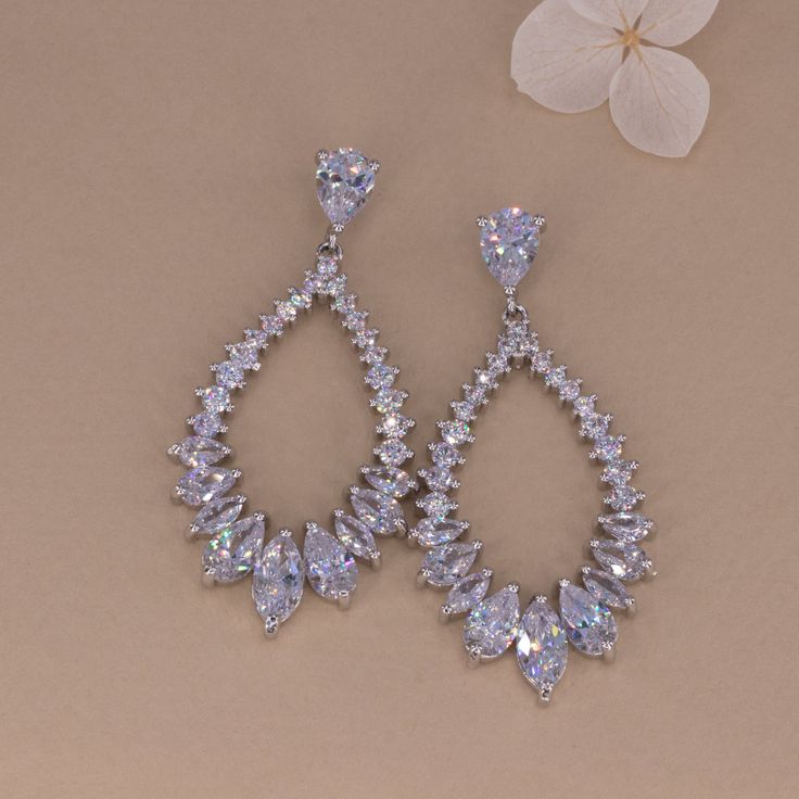 Pull your hair back to make these earrings pop as they beautifully catch the light. These chandelier teardrop shaped crystal earrings with multi-sized cubic zirconia crystal paved will sparkle with every step you take. Color: Silver plated, clear Drop: 7x9 mm Width: 25x43 mm Closure: Push back Material: Cubic Zirconia & Brass with Silver plated, topped off with clear coating for an extra layer of durability. Dazzling Crystal Drop Chandelier Earrings, Cubic Zirconia Drop Chandelier Earrings, Glamorous Chandelier Drop Earrings With Sparkling Stones, Dazzling Pear-shaped Cubic Zirconia Earrings, Diamond Teardrop Chandelier Earrings, Silver Chandelier Earrings With Diamond Accents, Dazzling Diamond Teardrop Chandelier Earrings, Diamond Teardrop Chandelier Earrings With Sparkling Stones, Crystal Drop Chandelier Earrings With Sparkling Stones