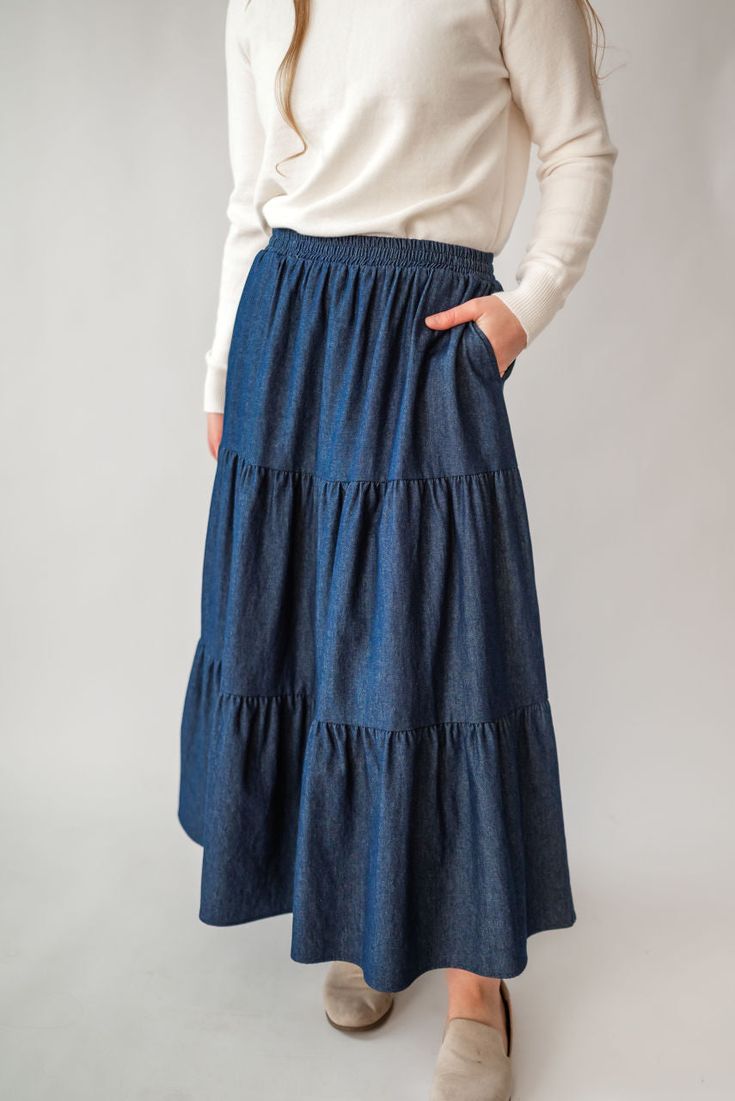 Perfect for a spring picnic or an everyday morning, the 'Celeste' skirt is so lovely and versatile! Constructed from lightweight cotton denim for a comfortable fit that moves with you, this skirt features hidden side pockets and an elastic waistband. Falling in ankle-length tiers, this comfortable skirt will compliment any simple top. Fit: true to size! Style: functioning pockets, elastic waist, tiered Color: dark wash Fabric content: 100% cotton Care instructions: wash gentle cycle, cold; lay f Spring Picnic, Comfortable Skirts, Be Intentional, Simple Top, Modest Clothing, Garment Labels, Curated Gifts, Tier Skirt, Tiered Skirt