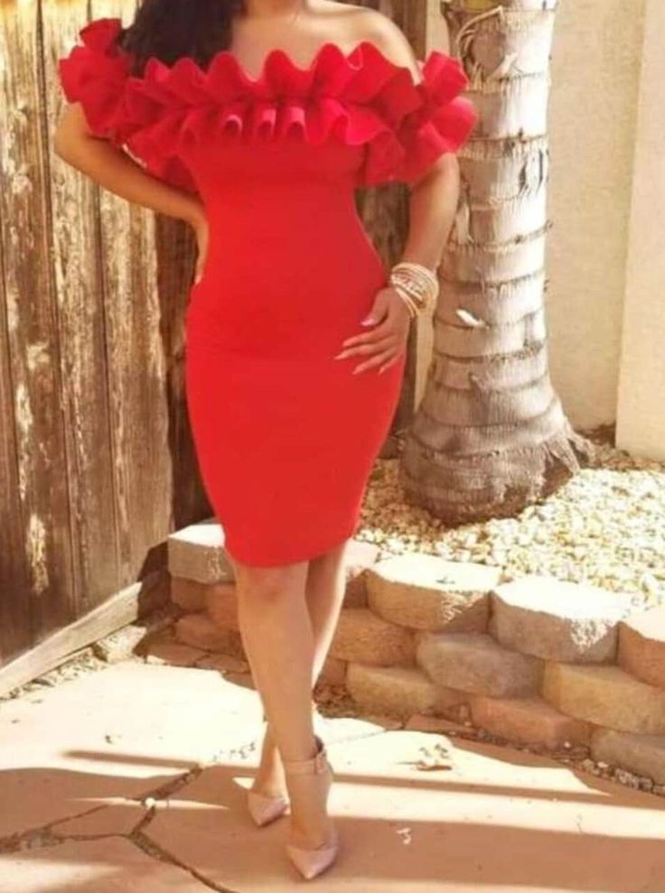 a woman in a red dress posing for the camera